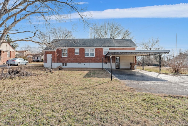 rear view of house with a carport and a yard