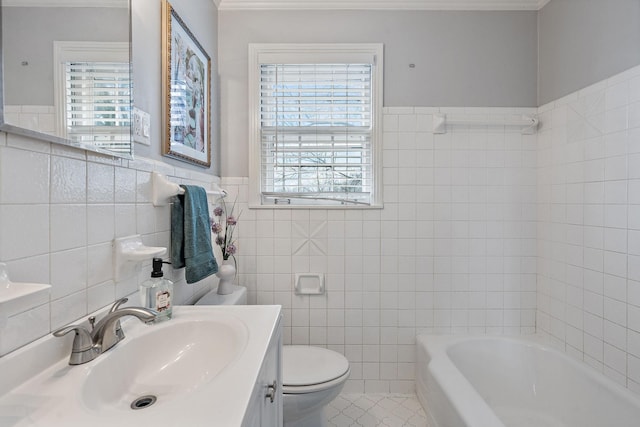 bathroom with a bathtub, vanity, tile patterned floors, and tile walls