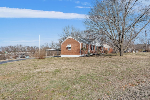 view of side of property with a lawn and a carport