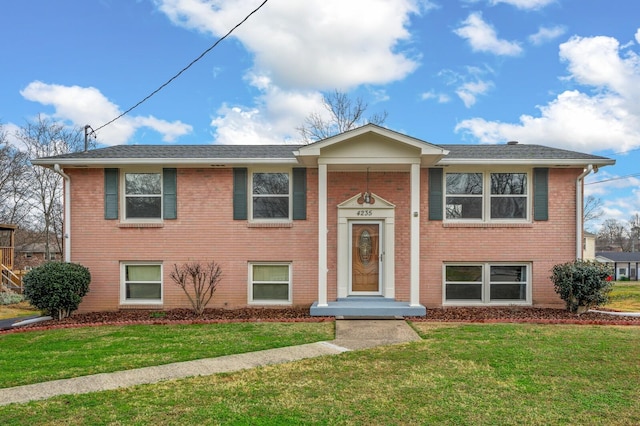 raised ranch with a front lawn