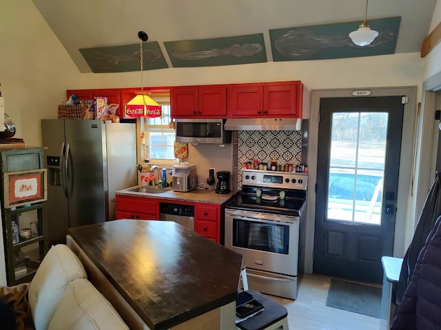 kitchen featuring stainless steel appliances, decorative backsplash, sink, hanging light fixtures, and ventilation hood