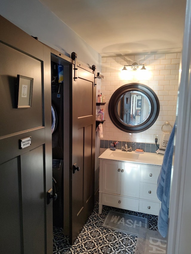 bathroom with vanity, decorative backsplash, and tile patterned flooring