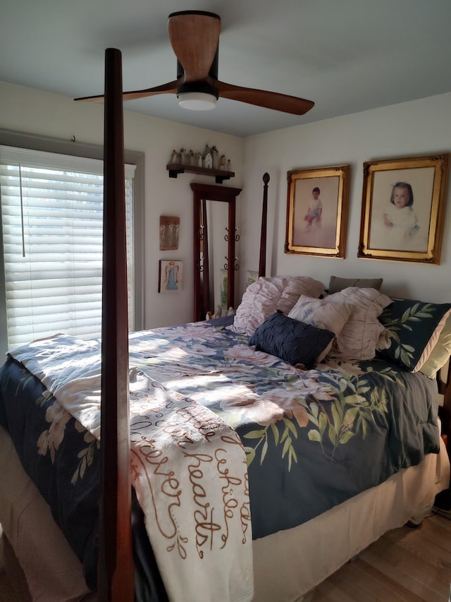 bedroom with hardwood / wood-style floors and ceiling fan