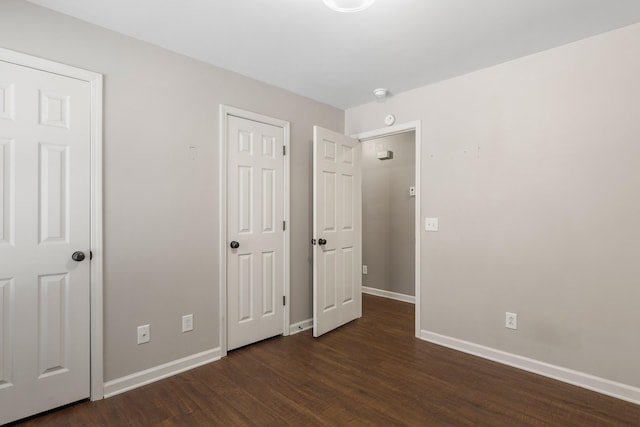 unfurnished bedroom with dark hardwood / wood-style floors