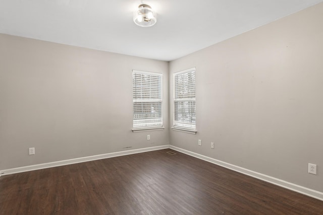 spare room featuring dark wood-type flooring