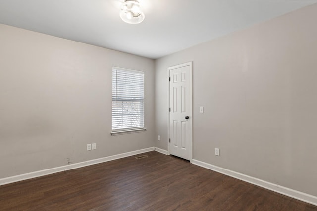 empty room with dark hardwood / wood-style flooring