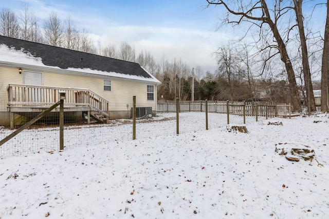 exterior space with central AC unit and a wooden deck