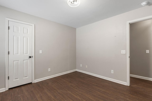 empty room with dark wood-type flooring