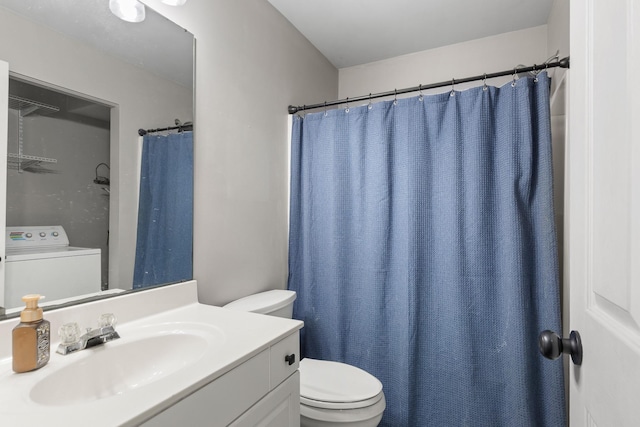 bathroom featuring toilet, washer / dryer, and vanity