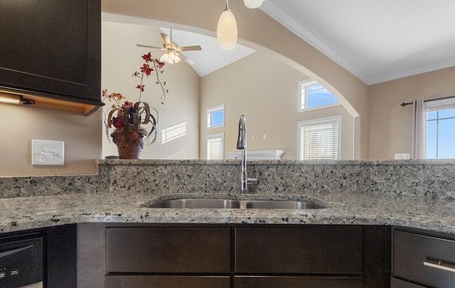 kitchen featuring light stone countertops, sink, and plenty of natural light