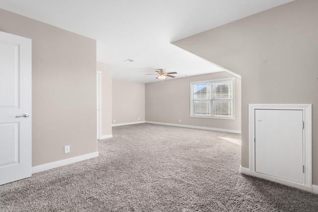 carpeted spare room with ceiling fan