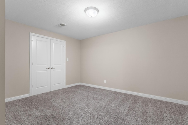 unfurnished bedroom with a closet and carpet flooring