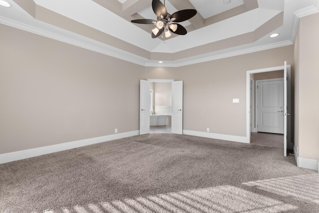 unfurnished bedroom featuring ceiling fan, a raised ceiling, ornamental molding, and carpet floors