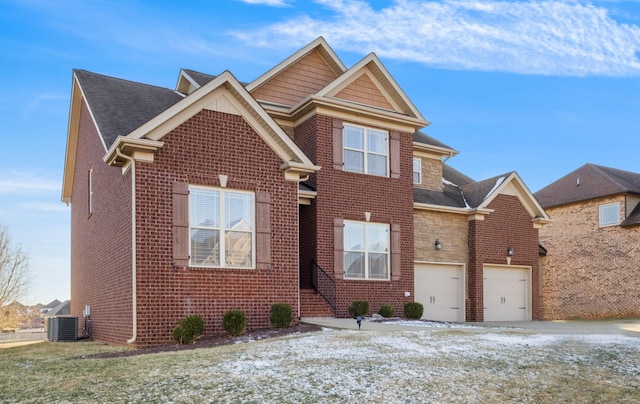 view of front of house featuring a garage and central AC unit