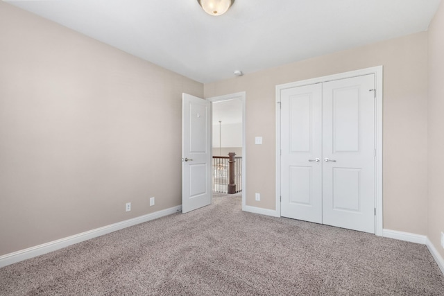 unfurnished bedroom with a closet and carpet