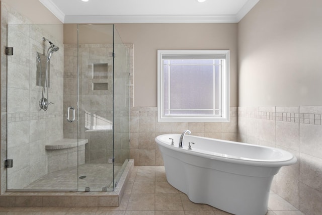 bathroom featuring tile walls, separate shower and tub, and crown molding