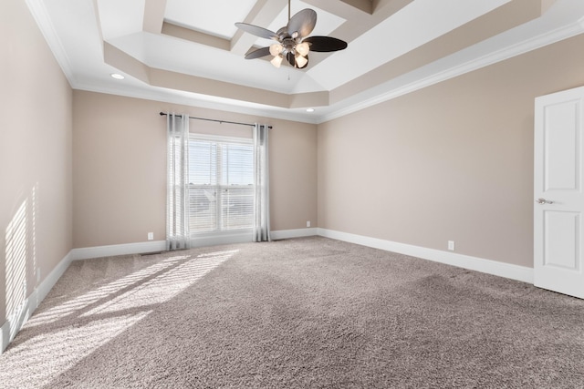 unfurnished room featuring ceiling fan, a tray ceiling, ornamental molding, and carpet flooring