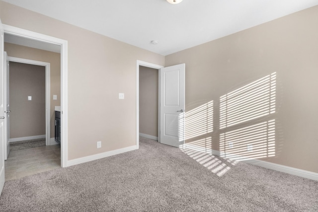 unfurnished room featuring light carpet