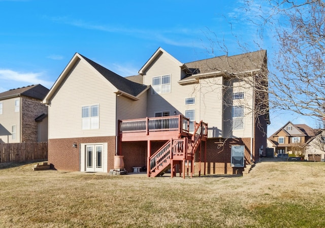 back of house with french doors, a lawn, and a wooden deck