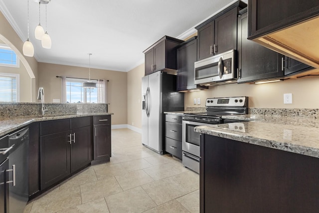 kitchen with dark brown cabinets, hanging light fixtures, appliances with stainless steel finishes, sink, and ornamental molding