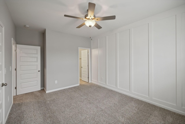 unfurnished bedroom featuring baseboards, carpet floors, two closets, and a ceiling fan