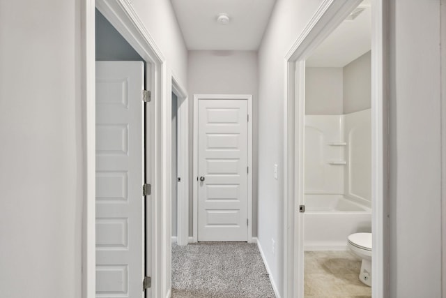 hallway featuring light colored carpet