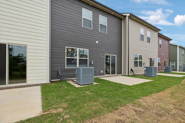 back of house featuring a yard, a patio, and central AC