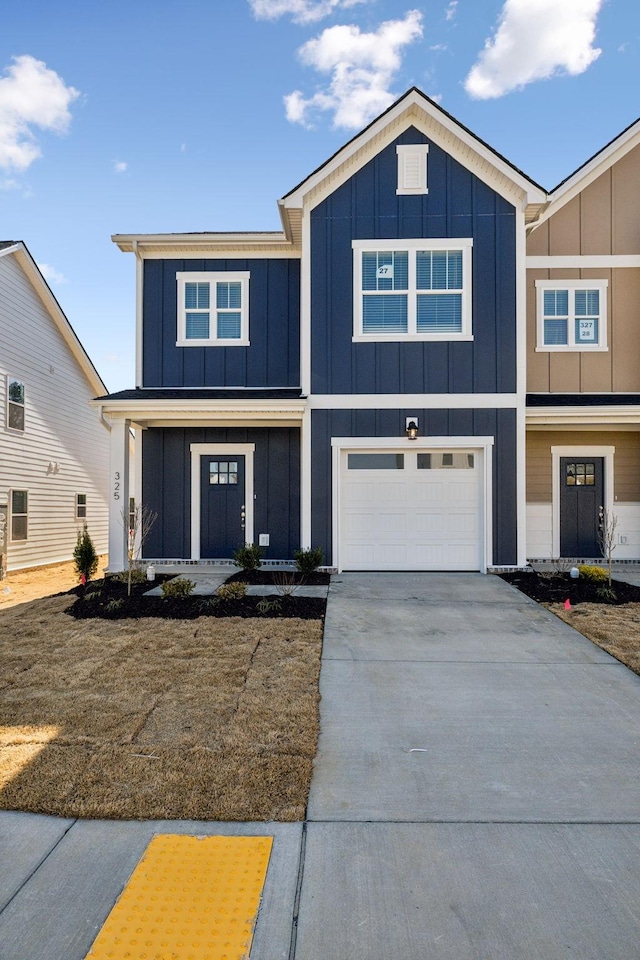 view of front of home with a garage, board and batten siding, and driveway