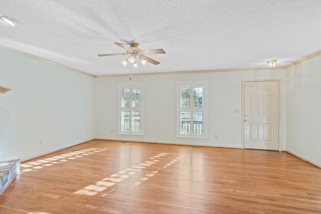 empty room featuring light wood-type flooring, a textured ceiling, ceiling fan, and ornamental molding