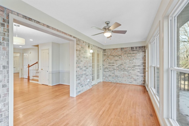 interior space with ceiling fan and french doors