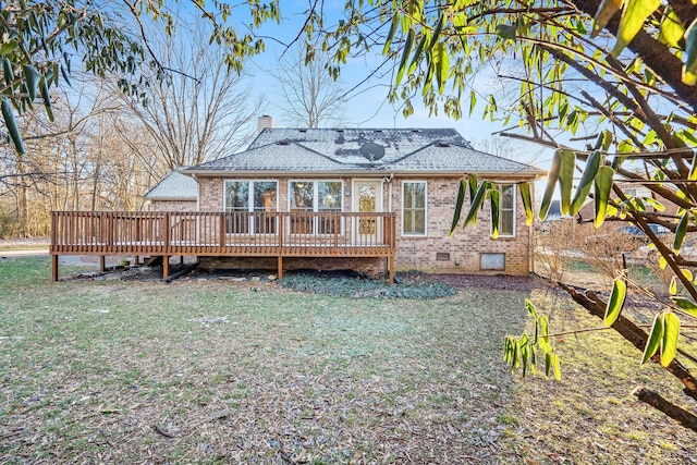 back of property with a lawn and a wooden deck