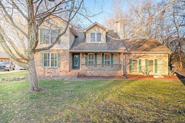 cape cod home featuring covered porch and a front lawn