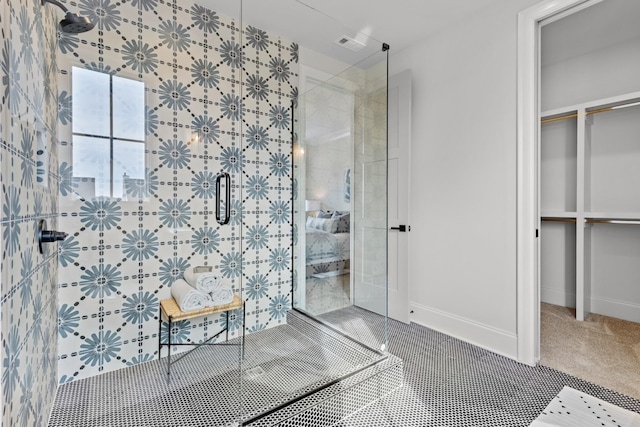 bathroom with tile patterned flooring and a shower with shower door