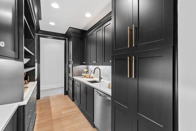 kitchen featuring sink, backsplash, wall oven, stainless steel dishwasher, and light hardwood / wood-style flooring