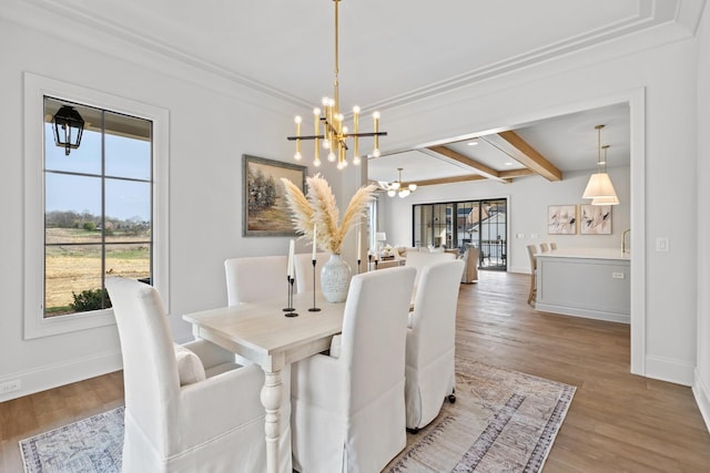 dining area featuring a chandelier, beamed ceiling, and light hardwood / wood-style floors