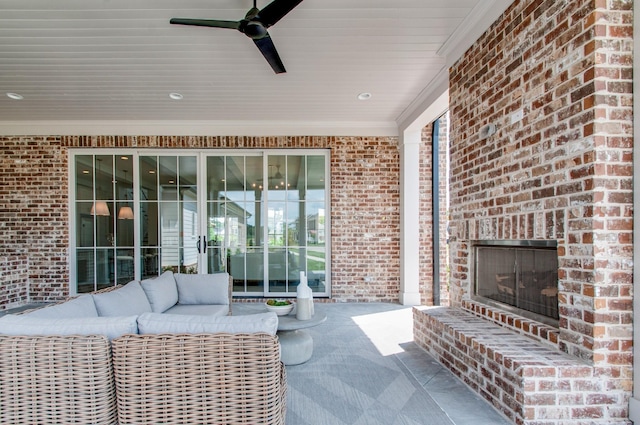 view of patio featuring ceiling fan and an outdoor living space with a fireplace