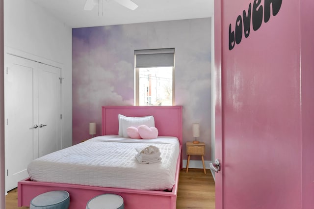 bedroom with ceiling fan and hardwood / wood-style flooring