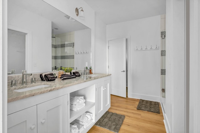 bathroom featuring vanity, hardwood / wood-style flooring, and a shower