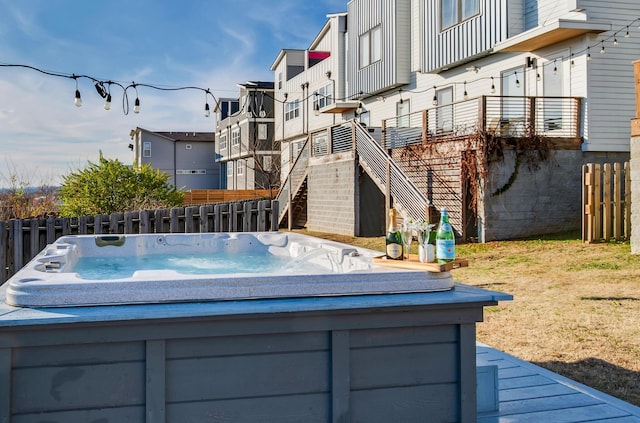 view of pool featuring a wooden deck and a hot tub