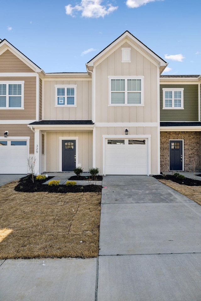 view of front facade featuring concrete driveway, an attached garage, and board and batten siding