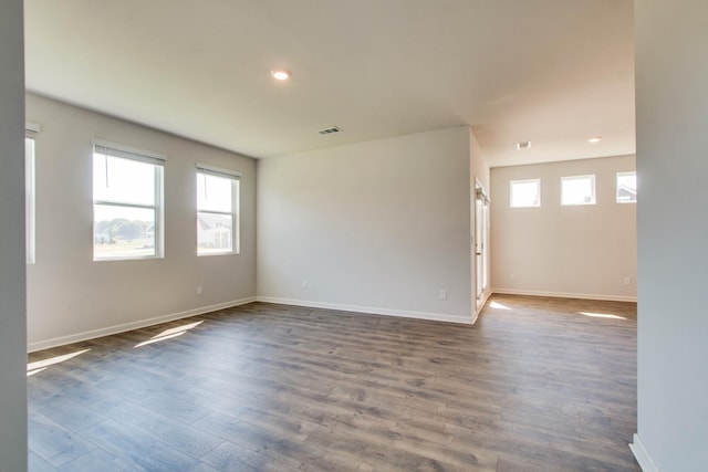 unfurnished room with dark wood-type flooring