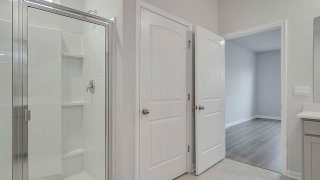 bathroom with vanity and a shower with shower door