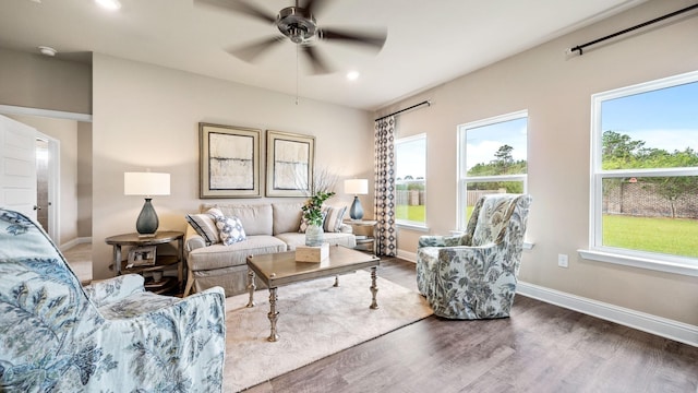 living room featuring ceiling fan and dark wood-type flooring