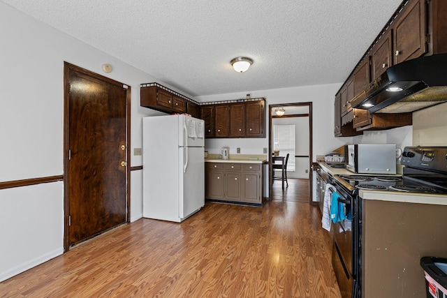 kitchen with white refrigerator, a textured ceiling, black range with electric stovetop, light hardwood / wood-style floors, and dark brown cabinetry