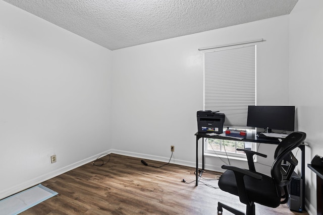 home office with hardwood / wood-style floors and a textured ceiling