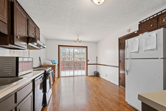 kitchen featuring dishwasher, dark brown cabinetry, electric range, light hardwood / wood-style flooring, and white refrigerator