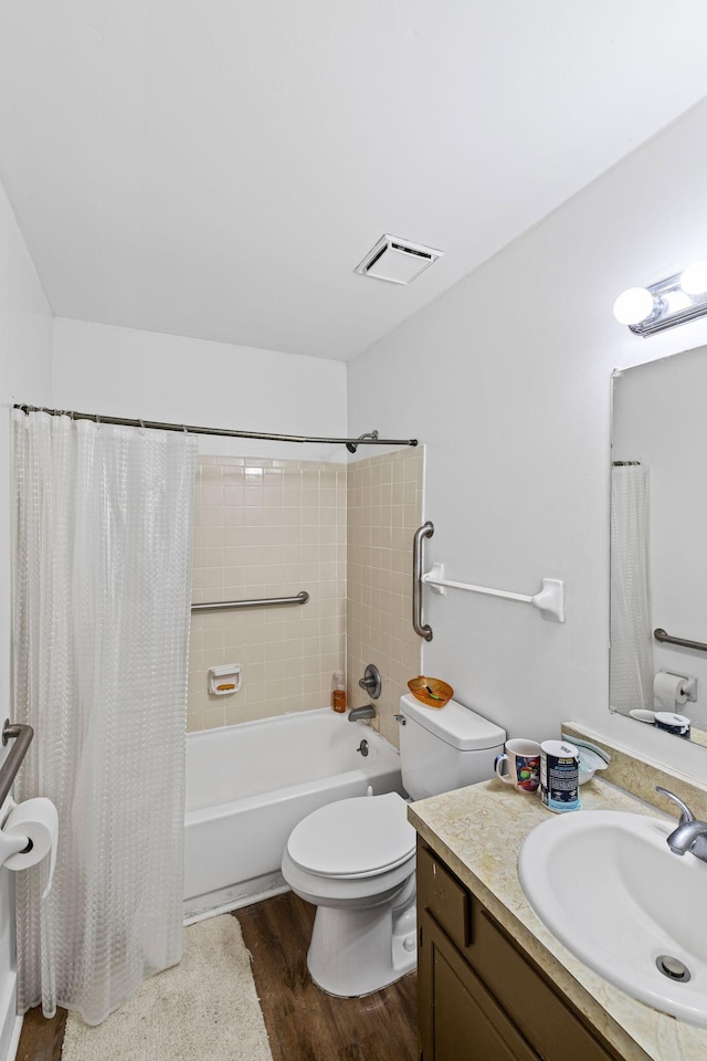 full bathroom with hardwood / wood-style floors, toilet, vanity, and shower / bath combo