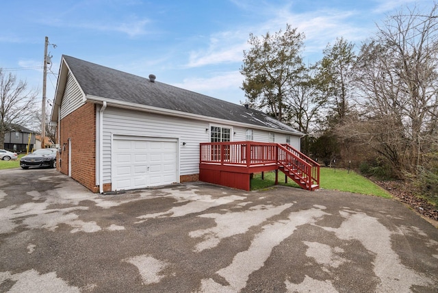 view of front of property with a deck and a garage