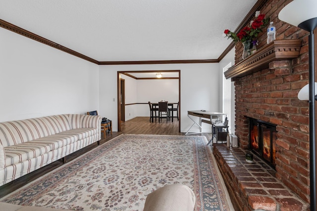 living room featuring ornamental molding, a fireplace, dark hardwood / wood-style flooring, and a textured ceiling