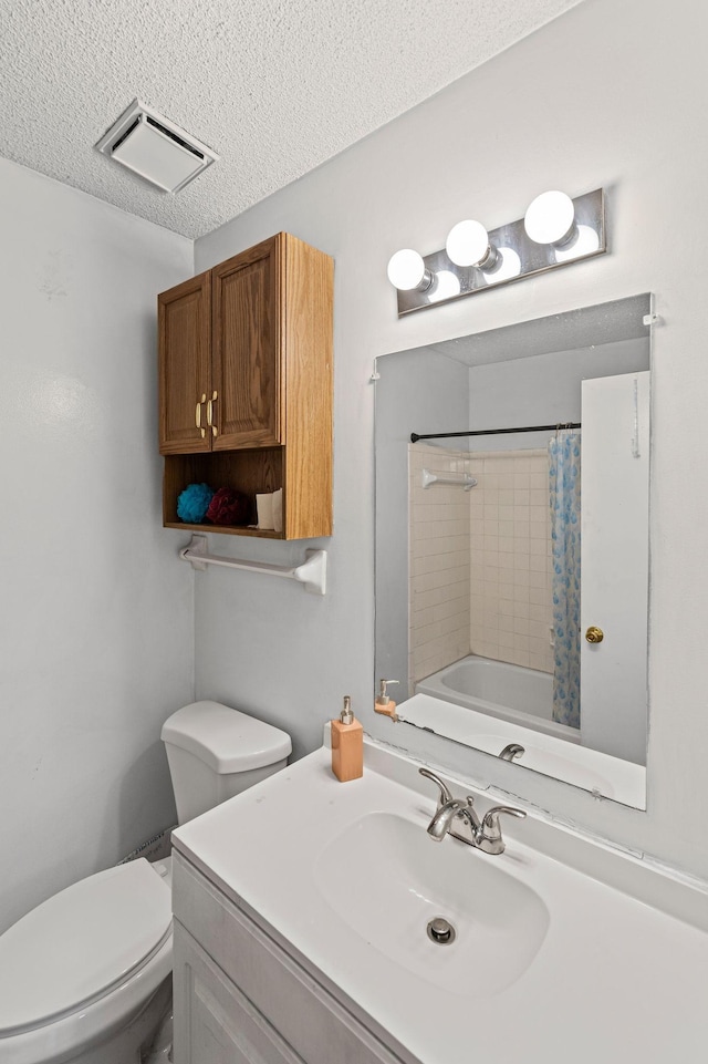 full bathroom featuring vanity, toilet, shower / bath combo, and a textured ceiling